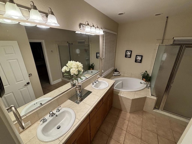 bathroom featuring tile patterned floors, vanity, and shower with separate bathtub