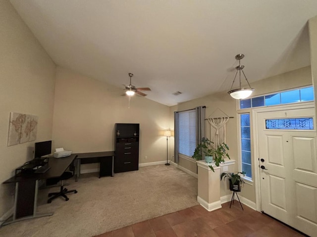 carpeted entrance foyer with ceiling fan and vaulted ceiling