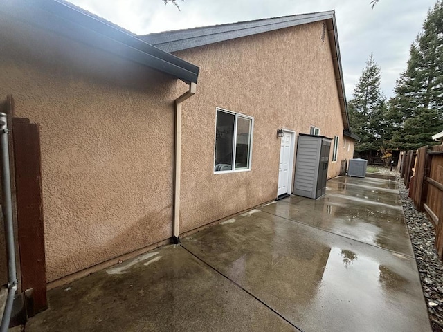 view of home's exterior featuring central air condition unit and a patio area