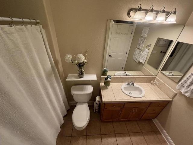 bathroom with tile patterned floors, vanity, and toilet