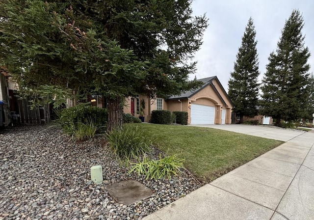 obstructed view of property with a garage and a front lawn