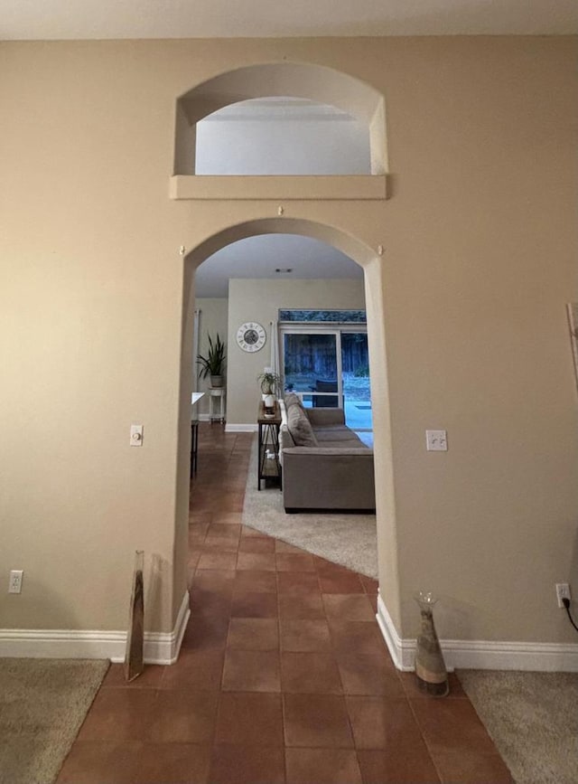 hall with dark tile patterned floors