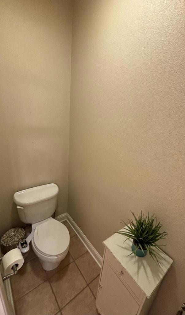 bathroom with tile patterned flooring and toilet