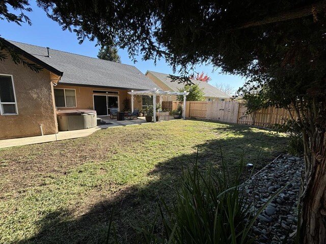 view of yard featuring a patio, a hot tub, and a pergola