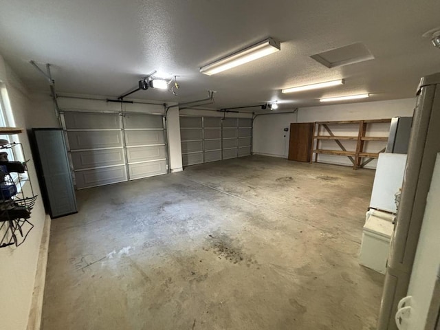 garage featuring stainless steel fridge and a garage door opener