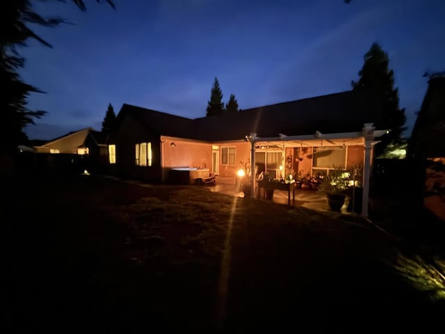 back house at night with a patio area