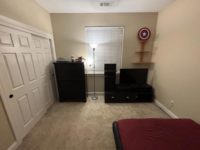 carpeted bedroom featuring a closet