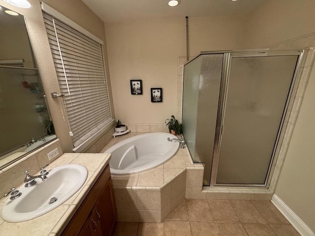 bathroom featuring tile patterned flooring, vanity, and independent shower and bath