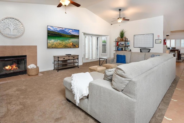 tiled living room with a fireplace, ceiling fan, plenty of natural light, and vaulted ceiling