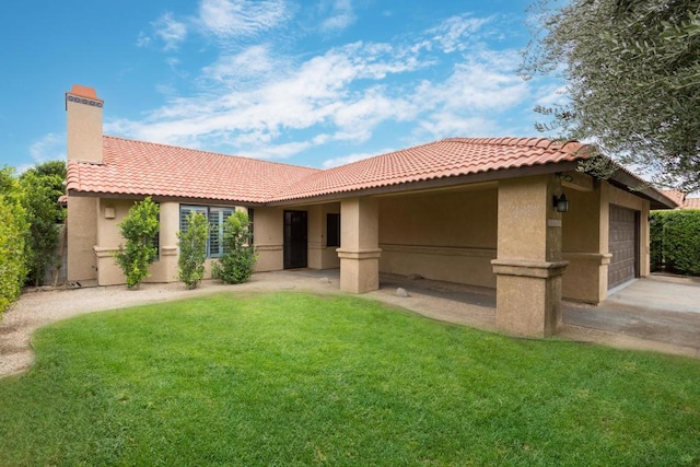 view of front of home with a garage and a front lawn