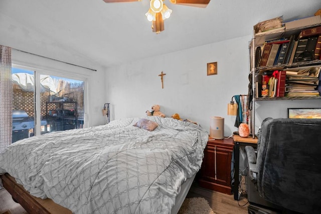 bedroom featuring access to outside, ceiling fan, and hardwood / wood-style flooring