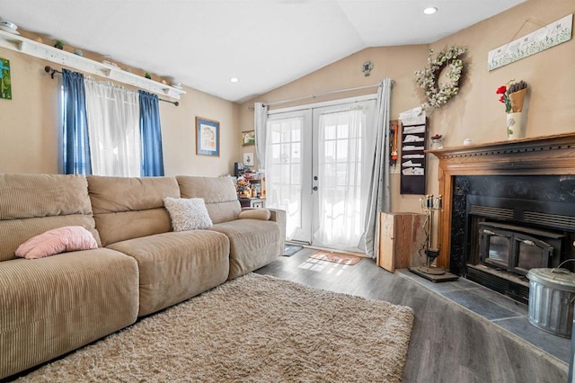 living room featuring lofted ceiling, french doors, and dark hardwood / wood-style floors