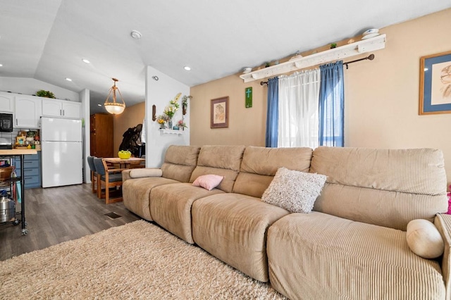 living room featuring hardwood / wood-style floors and vaulted ceiling