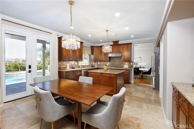 dining room with plenty of natural light, french doors, crown molding, and a chandelier