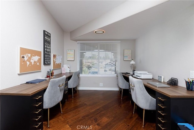 office space with vaulted ceiling and dark wood-type flooring