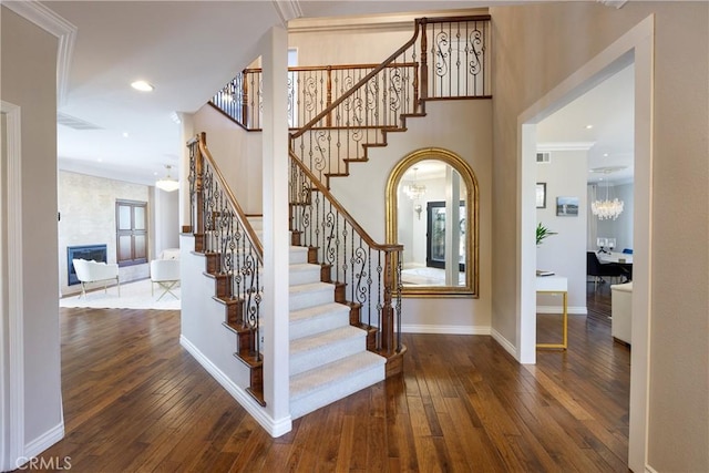 stairway featuring hardwood / wood-style floors and crown molding