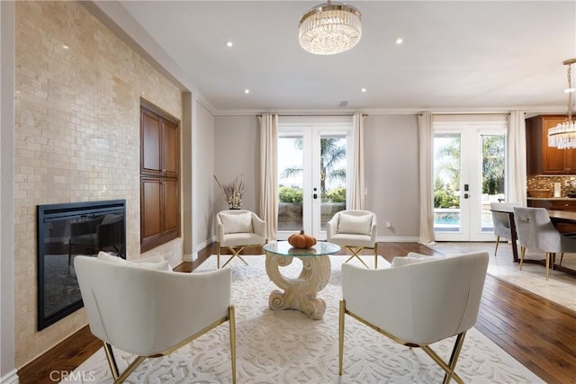 living room with light wood-type flooring, french doors, and a wealth of natural light