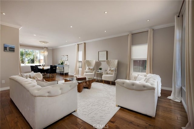 living room with a chandelier, dark hardwood / wood-style flooring, and ornamental molding