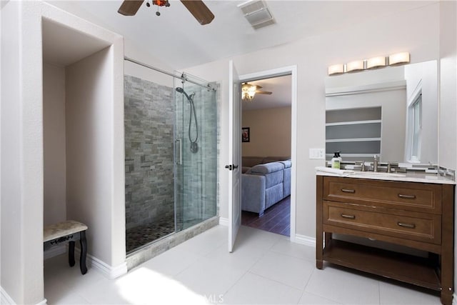 bathroom with ceiling fan, tile patterned floors, vanity, and walk in shower