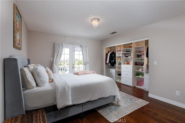 bedroom with dark hardwood / wood-style flooring, a closet, and french doors