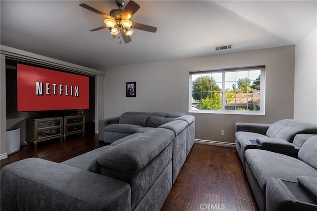 living room featuring ceiling fan and dark hardwood / wood-style flooring