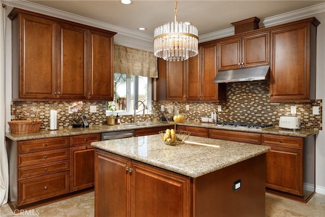 kitchen featuring a kitchen island, stainless steel appliances, sink, backsplash, and hanging light fixtures