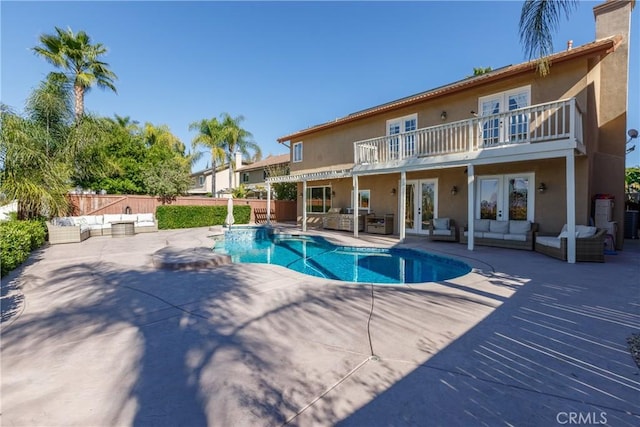 view of swimming pool featuring a patio area, an outdoor living space, and french doors