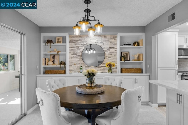 dining room with light carpet and a textured ceiling