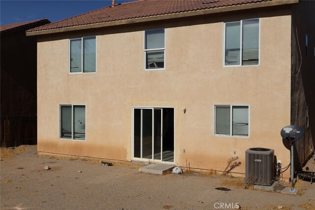 rear view of house with central AC