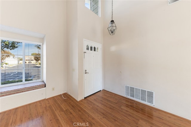 entrance foyer featuring a high ceiling and hardwood / wood-style flooring