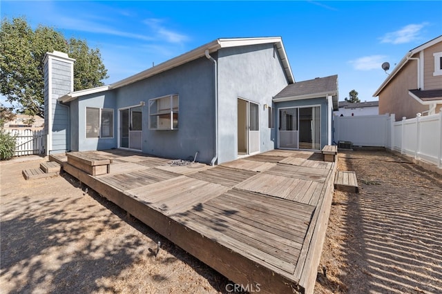 back of house featuring a wooden deck