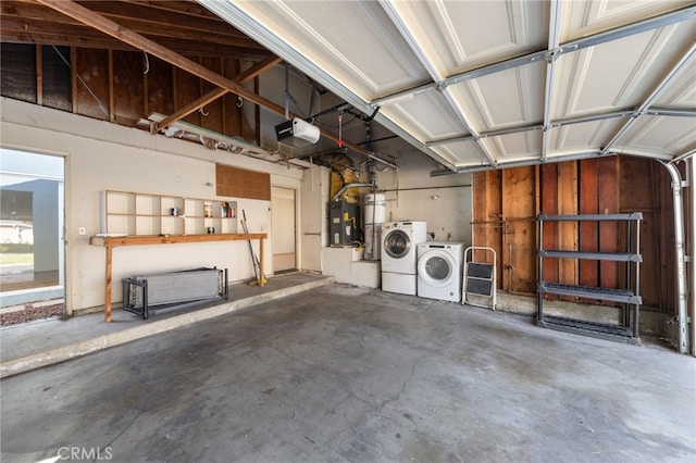 garage with a garage door opener and independent washer and dryer