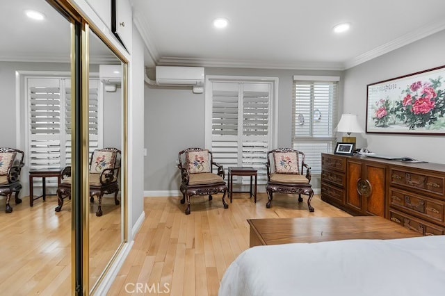 bedroom featuring a wall mounted AC, crown molding, and light wood-type flooring