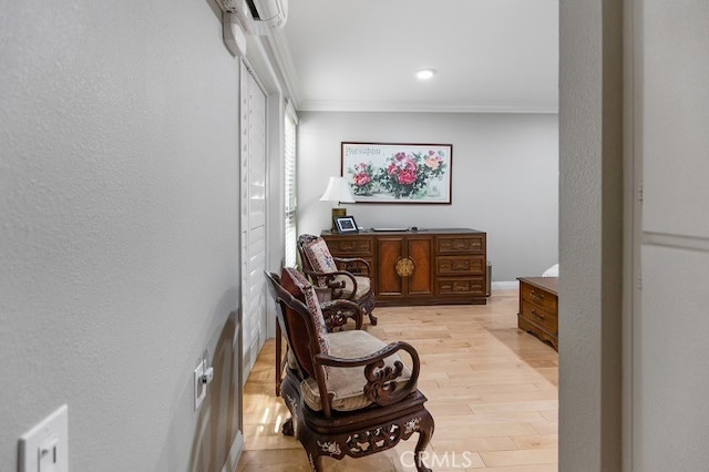 living area featuring light hardwood / wood-style flooring and crown molding