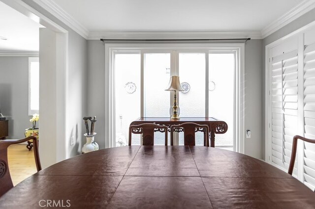 dining room featuring plenty of natural light and ornamental molding