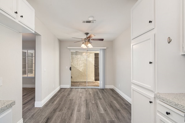 foyer featuring ceiling fan and dark wood-type flooring