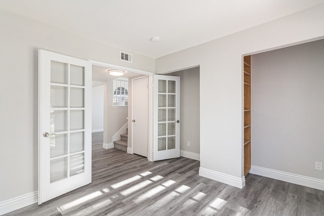 spare room with french doors and dark wood-type flooring