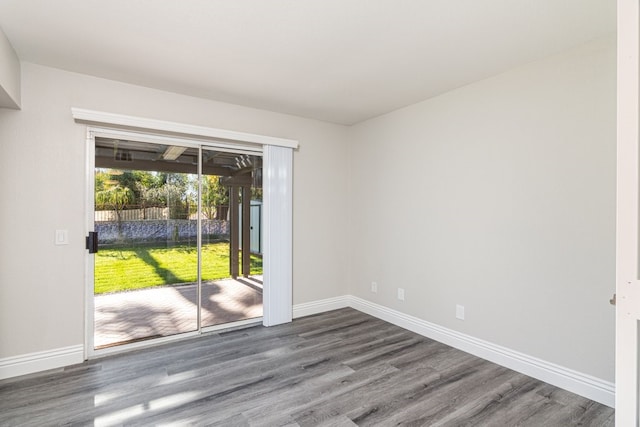 unfurnished room with dark hardwood / wood-style flooring