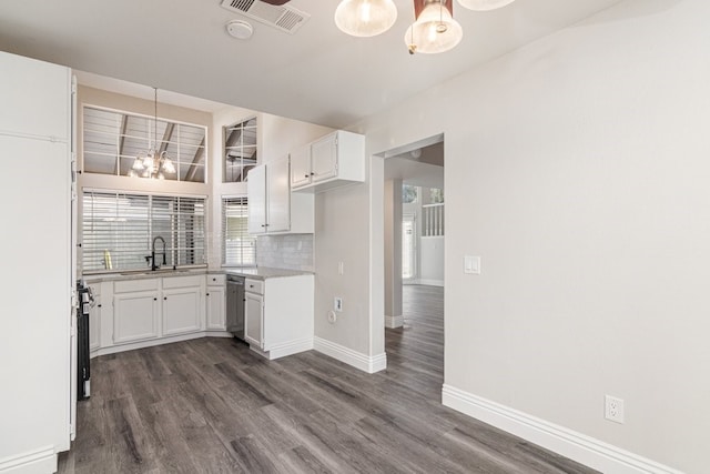 kitchen featuring white cabinetry, sink, stainless steel dishwasher, and dark hardwood / wood-style floors