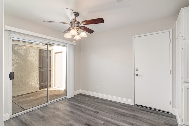 spare room featuring wood-type flooring and ceiling fan