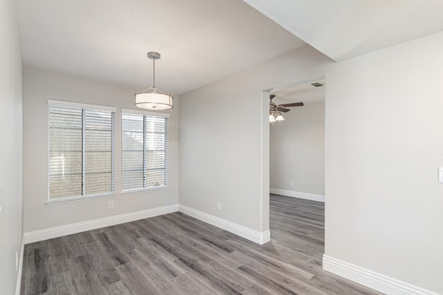 unfurnished room featuring ceiling fan and dark wood-type flooring