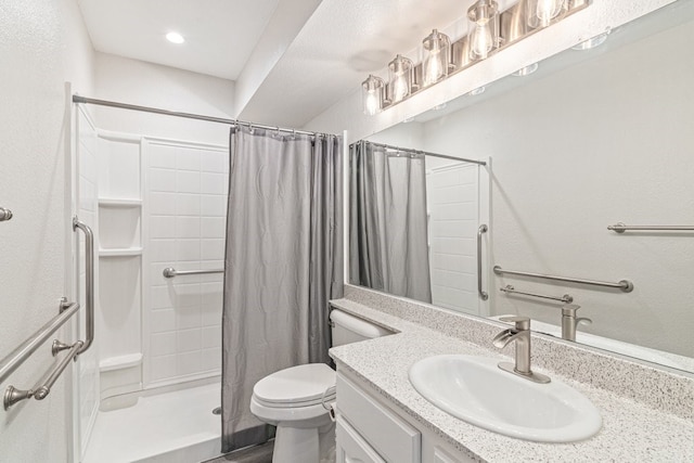 bathroom featuring vanity, toilet, and walk in shower