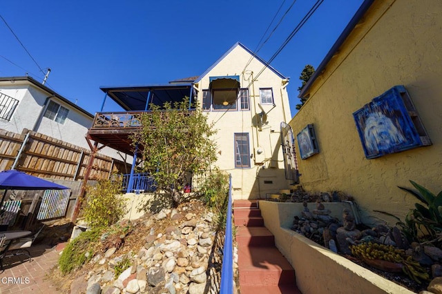 rear view of property with a wooden deck