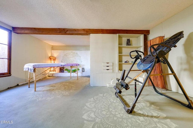 exercise area featuring a textured ceiling