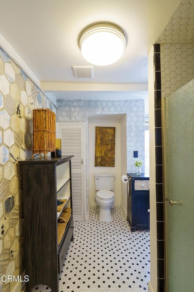 bathroom featuring toilet and tile patterned flooring