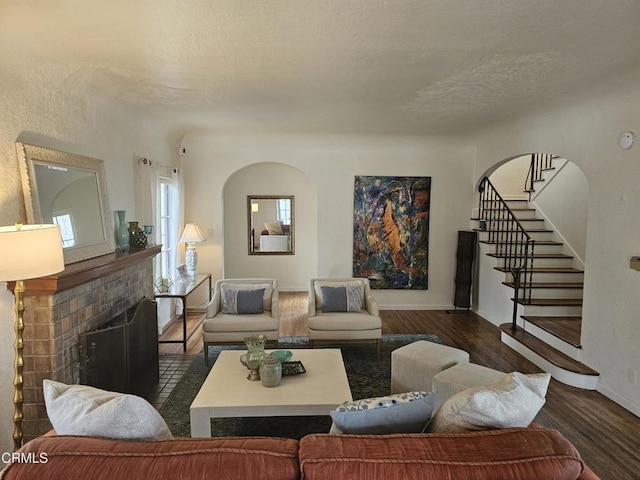 living room with dark wood-type flooring and a textured ceiling