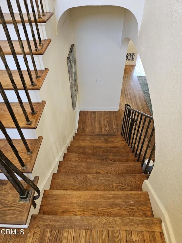 stairs with wood-type flooring