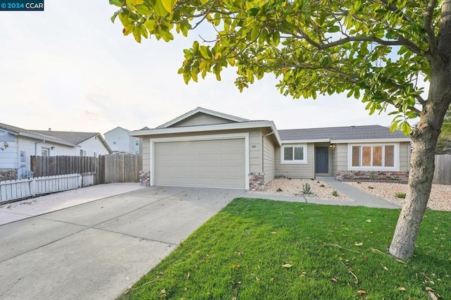 single story home featuring a garage and a front yard