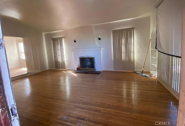 1816 W 76th St, Los Angeles, CA 90047 - unfurnished living room with a fireplace with raised hearth and hardwood / wood-style floors