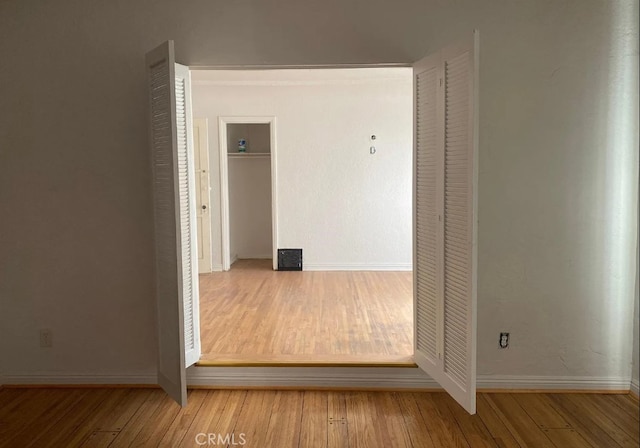 hallway with light wood-type flooring